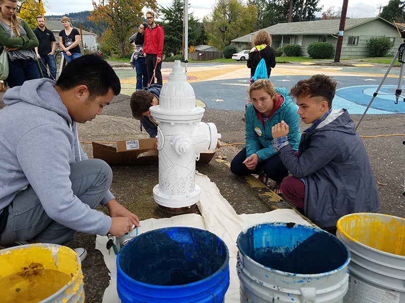 Brian Soutavong opens paint with classmates Emily Fagan and Andrei Eugenio