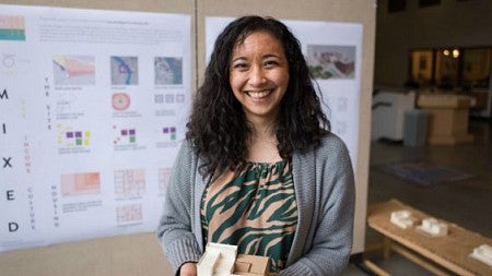 Ali Lau, an architecture graduate student, holds a model of her project. (Phillip Quinn/Emerald)