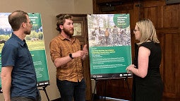 Marc Schlossberg and a SCYP participant explain findings to a community member