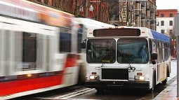 Photograph of a bus and a tram in Portland. 