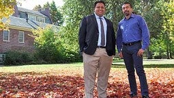 Two man standing under a tree in autumn