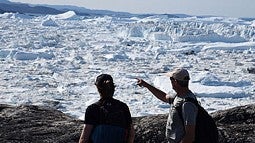 Photo of two people looking at glaciers