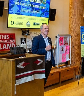 Photograph of the Dean of the Lundquist College of Business speaking at the SCYP kick-off. 